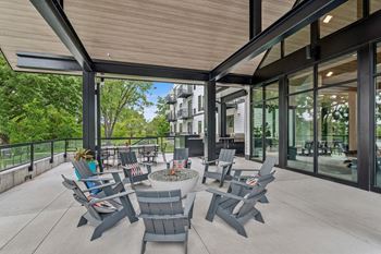 a patio with chairs and a fire pit